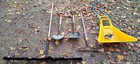 All five yard tools laid out on ground