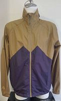 Front view of windbreaker showing two-tone design and full zipper