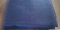Folded navy tulle fabric front view