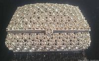 Front view of rhinestone covered metal trinket box, lid closed