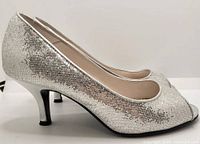 Left side profile of left shoe showing silver glitter upper and heel