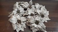 All eight silver fabric poinsettias spread out