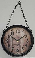Front view showing entire clock with chain hanger