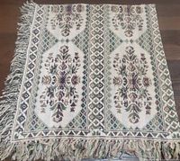 Full view of woven tablecloth showing pattern and fringe