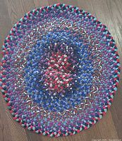 Full view of oval braided rag rug
