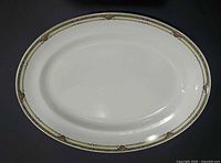 Full view of white oval platter with decorative border