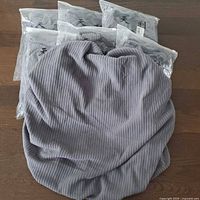 All seven packaged covers with one unfolded for texture view