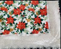 Full view showing poinsettia print center and lace border