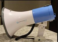 Side profile showing white cone, blue rear, Technical Pro branding, microphone hanging by coiled cord