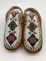 Top view showing full beadwork patterns on both moccasins
