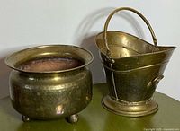 Both brass containers side by side