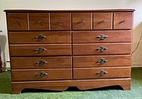 Front view of maple dresser showing drawers and hardware