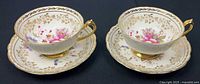 Two matching Paragon teacups on saucers, top view shows pattern and gilt
