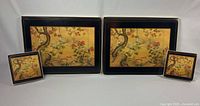 Two placemats and two coasters displayed showing Chinese Screen pattern
