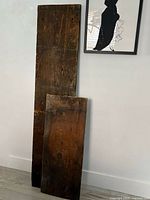 Two reclaimed wood boards leaning against wall