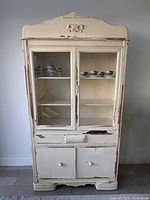 Front view of cream china cabinet