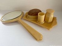 Full set showing mirror, tray, pin cushion, pin holder, talc jar
