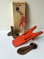 Group shot showing Vienco boot jack, original box, and two cast iron shoe lasts