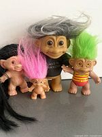 Group of troll dolls showing clothing and hair