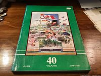 Front cover showing title, montage artwork and trilingual "40 Years/Ans/Jahre" text