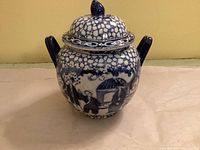 Front view of blue and white ceramic sugar bowl with lid