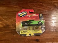 Front of sealed Adventure Wheels blister pack showing green 1971 Plymouth Hemi Cuda model car.