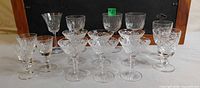 All fifteen stemmed cut-crystal glasses grouped together