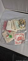 Overall view of sealed bag showing assorted string envelopes and loose coils