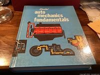 Front cover of textbook with title and engine illustration
