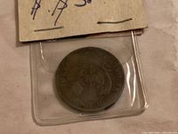 Token in plastic flip front view