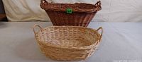 Both wicker baskets front view showing size difference