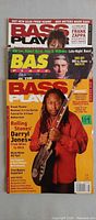 All three Bass Player magazines stacked showing covers