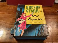 Front cover showing title, illustration, and spine damage