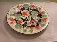 Top view showing raised multicolor floral design on platter
