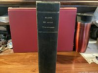 Spine view of hardbound volume showing cloth cover and spine title