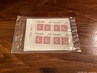Sealed cellophane pack showing front plate block of four Queen Victoria 30¢ stamps