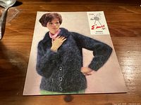 Front of Emu No.220 Filigree pattern leaflet featuring model in cardigan
