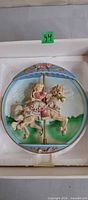 Front view of Carousel Dreams 3-D plate in box