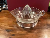 Side view showing full juicer, handle, spout and pressed pattern