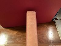 Spine of tan cloth hardcover showing title and author