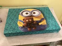 Closed Minions art case showing turquoise lid design
