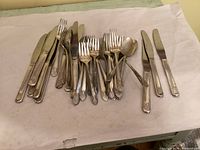 Pile showing mixed flatware and 5 knives laid separately
