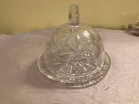 Crystal butter dish assembled with dome on plate