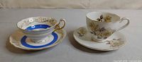 Both cup and saucer sets side by side