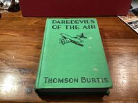 Front cover showing title, author, biplane illustration