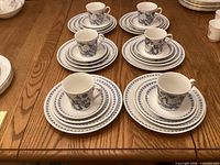 Six stacked place settings showing cup, saucer and three plate sizes
