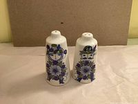 Front view of both shakers showing stylized man and woman graphics