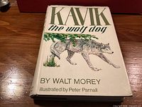 Front cover of book showing title, author, illustrator and wolf illustration