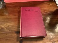 Closed red cloth book with title visible