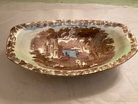 Top view of oval serving dish showing scenic transfer and border